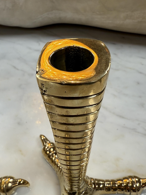 Brass candle holders designed in the shape of bird talons