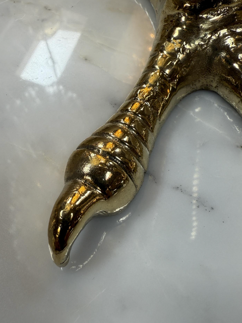 Brass candle holders designed in the shape of bird talons