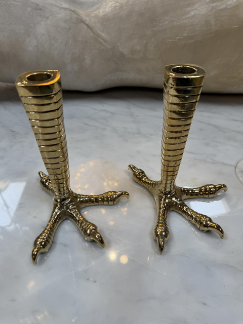 Brass candle holders designed in the shape of bird talons