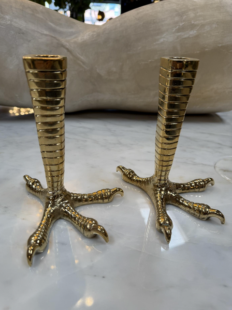 Brass candle holders designed in the shape of bird talons