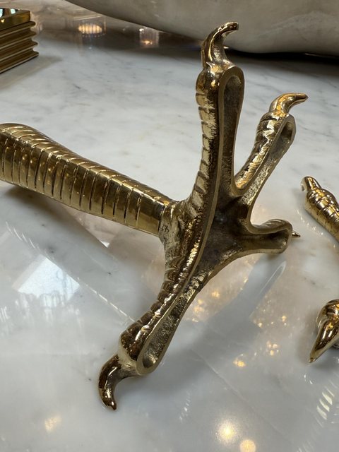 Brass candle holders designed in the shape of bird talons