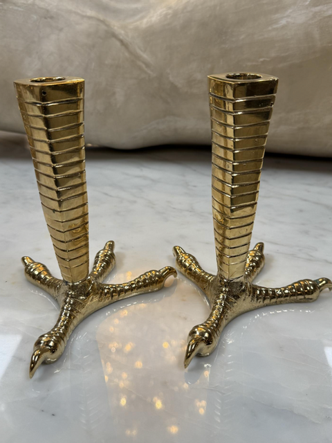 Brass candle holders designed in the shape of bird talons